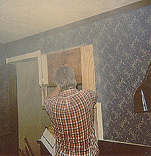 Monty Wells, hard at work, surrounded by dust as usual as he carefully removes part of the wall
between our light and airy dining room and our cave-like kitchen, 1988